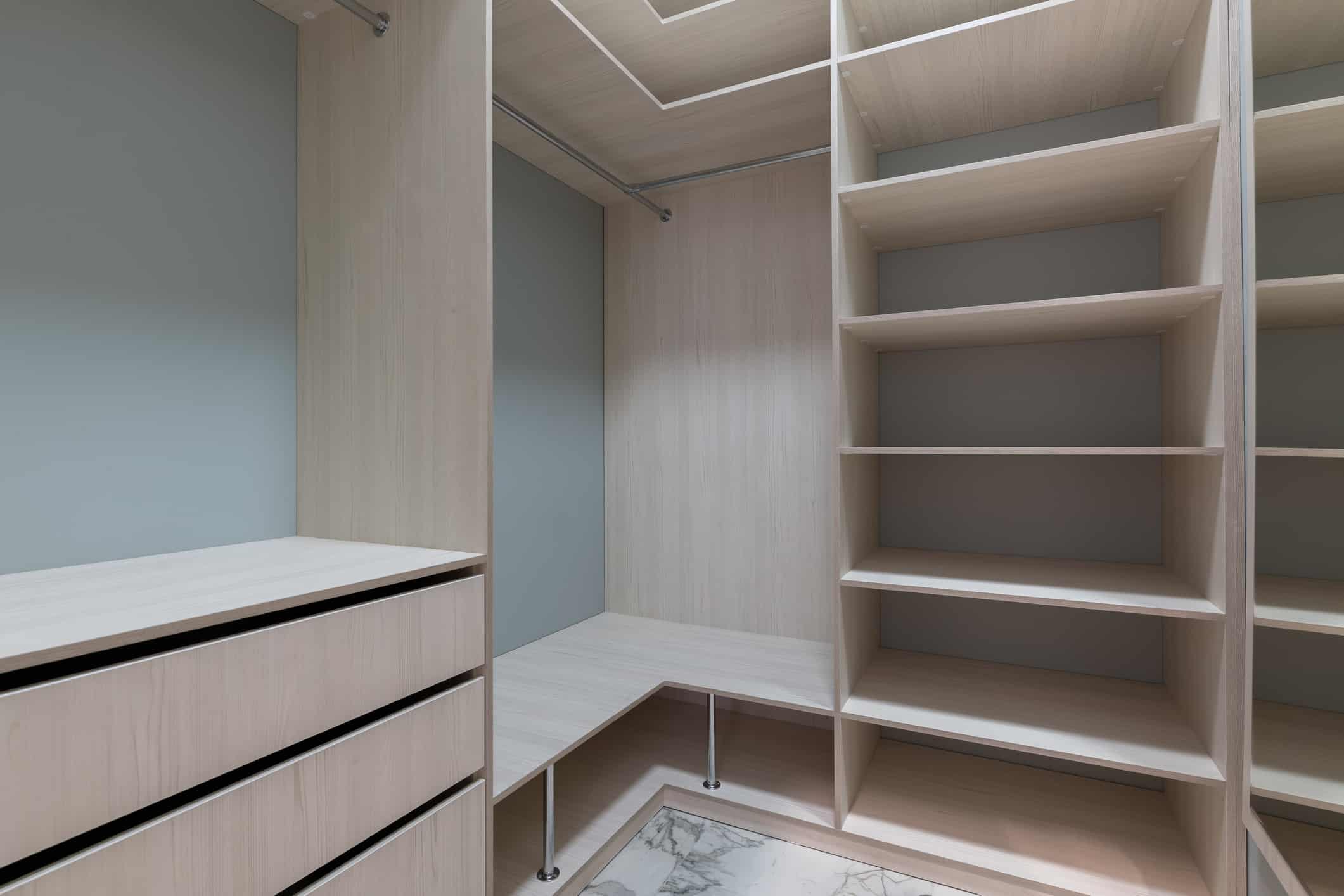 empty dressing room with wooden light furniture.